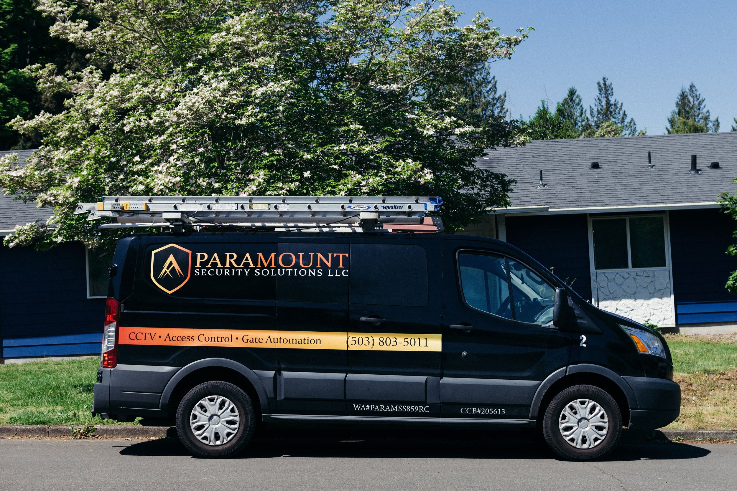 Paramount Security Solutions' van parked in front of a house, captured by brand photographer in Portland, OR
