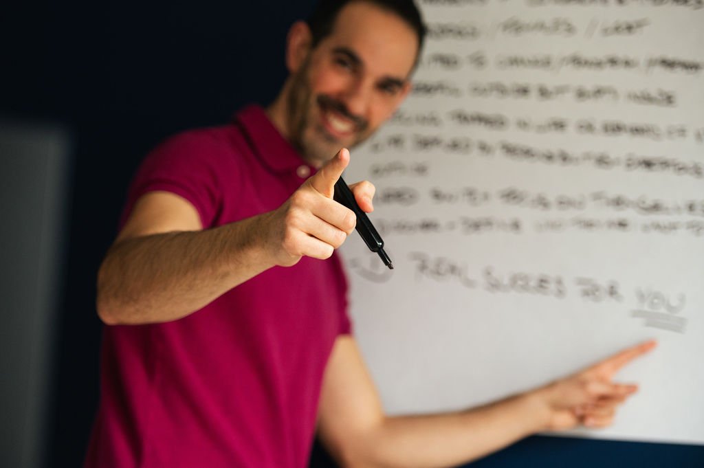  A personal brand photographer in Portland captures a man pointing at a whiteboard