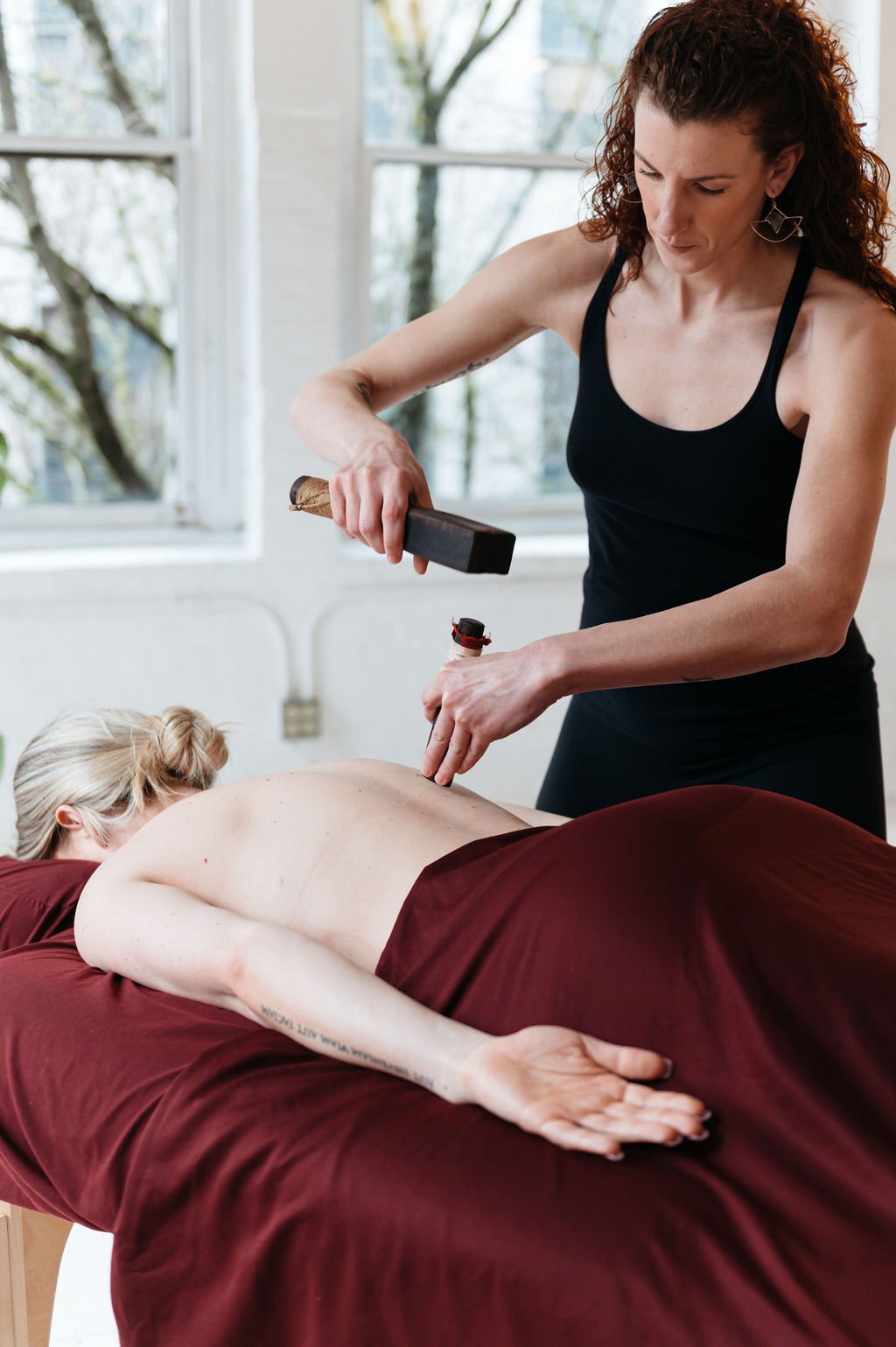A woman receiving a massage at Mettā Holistic Health in OR captured in Patrizia Montanari Brand photography