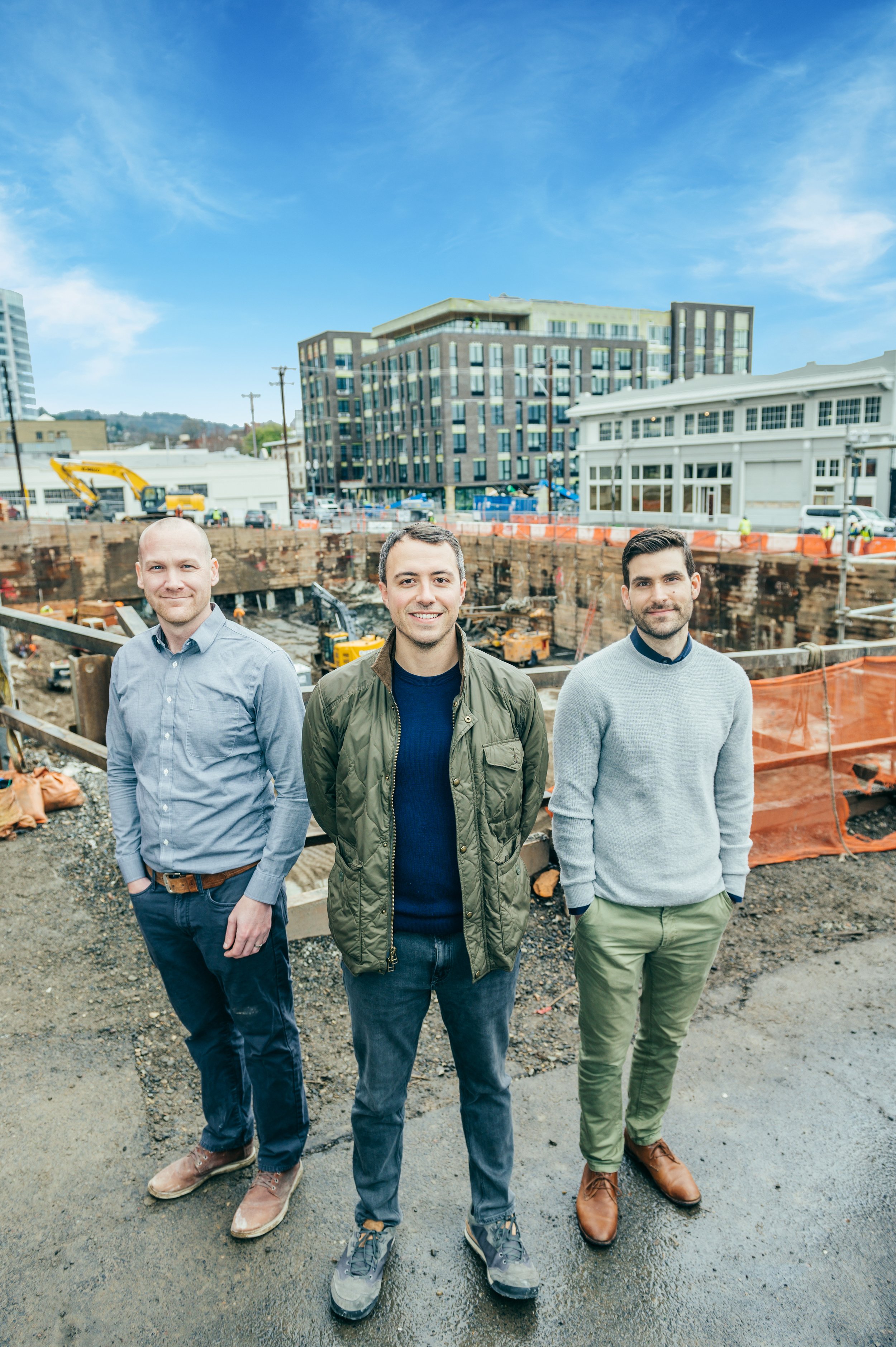 Three professionals from Wood Partners brand in front of a construction site captured by a Portland branding photographer.