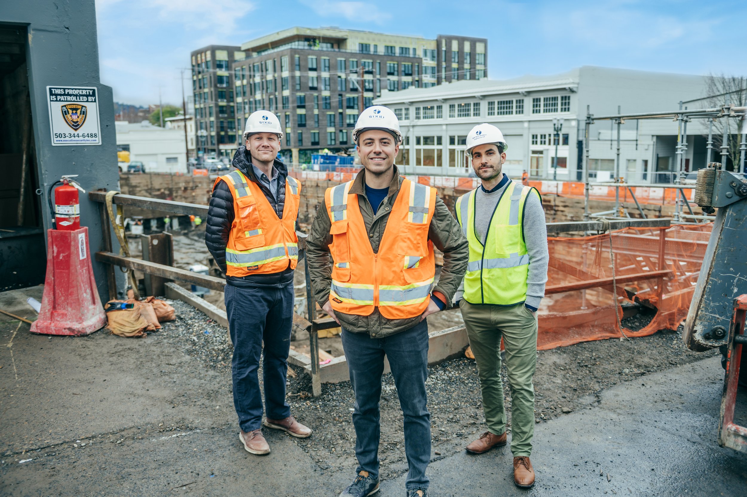 The construction developers standing in front of a  building, representing the WOOD PARTNERS brand.