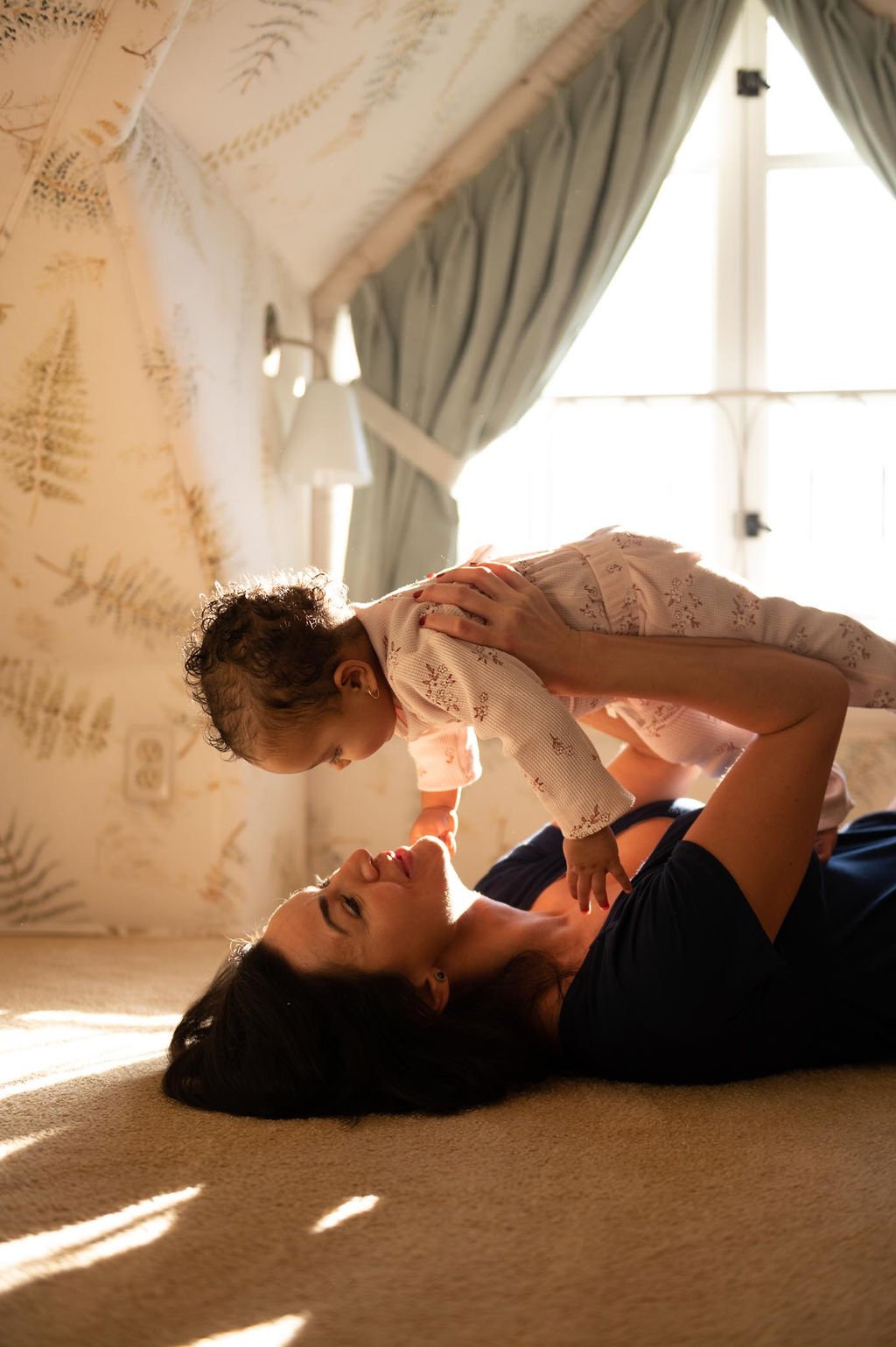 A mother, wearing brand loungewear, and her infant are captured in personal brand photography.