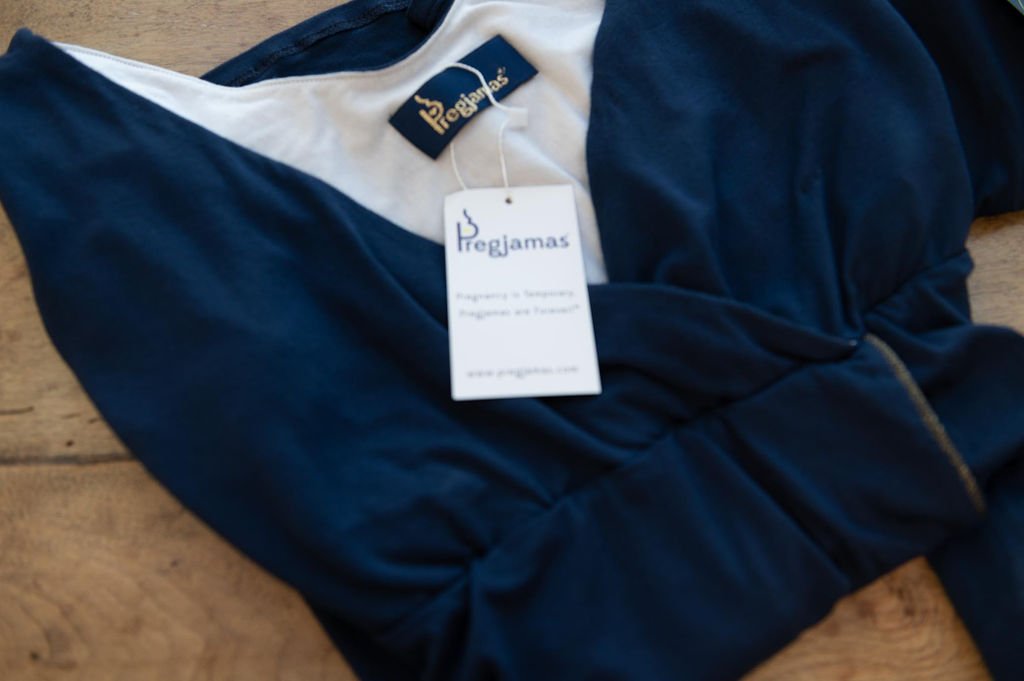 The best brand photographer in Portland captures a blue maternity dress with a tag, showcasing the luxury brand