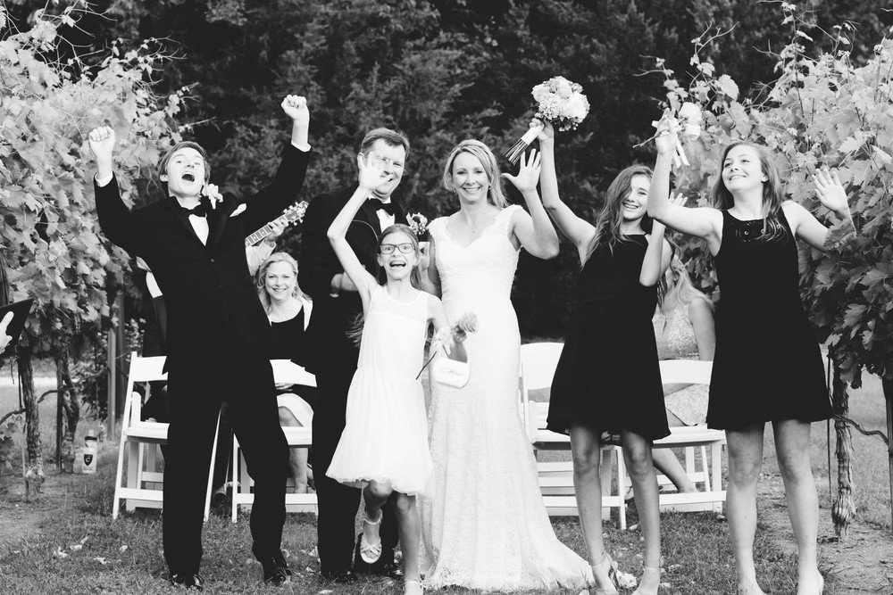 A black and white photo of a wedding party captured by a family event photographer.jpg