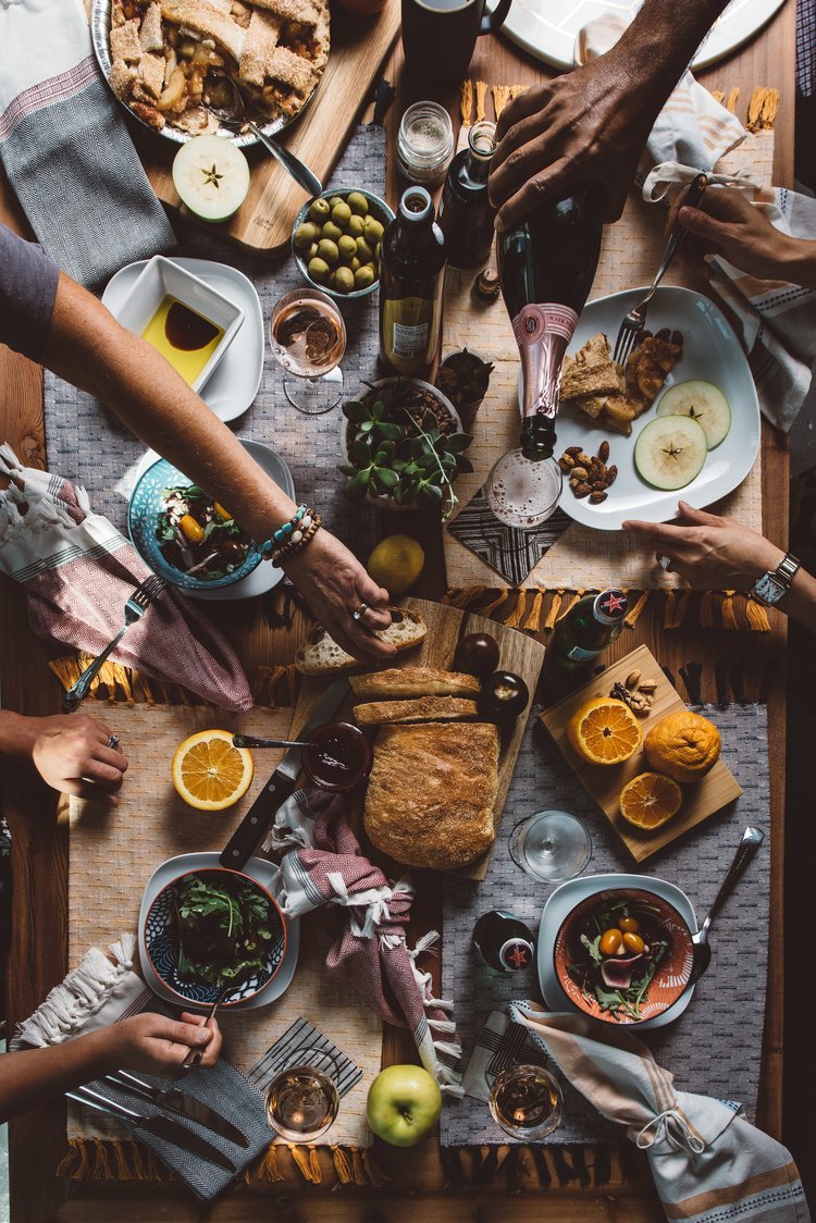 A captivating photo taken in Oregon by a food photographer, featuring a group of individuals seated around a table, savoring a delectable meal.jpg