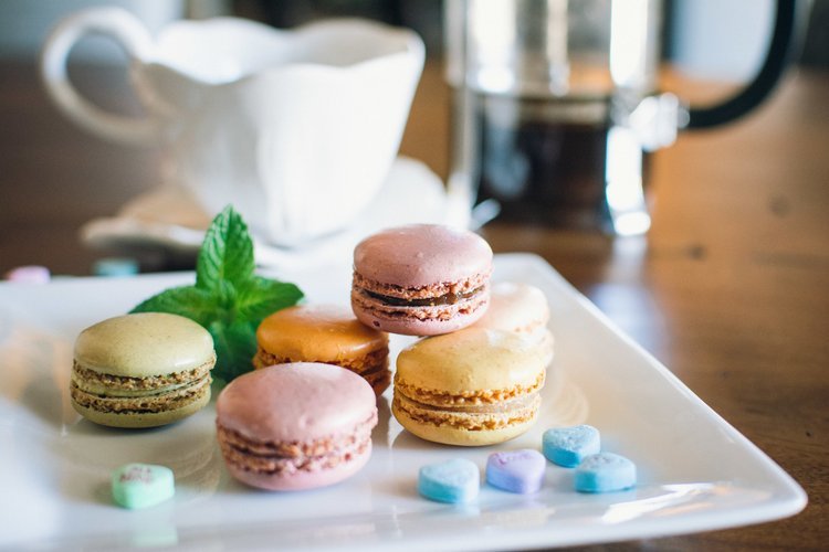 A plate of colorful macarons and a cup of coffee, captured by a food photographer in Portland.jpg