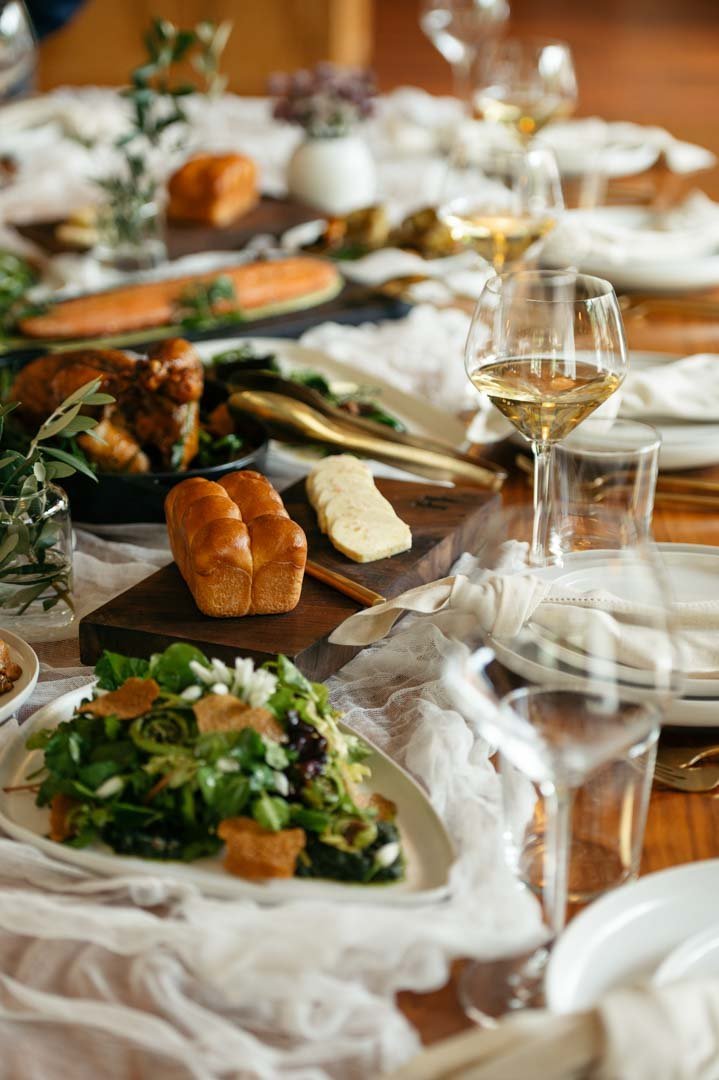 Impeccably set the table for a dinner party, showcasing wine glasses and plates, captured by the best food photographer in Portland.jpg
