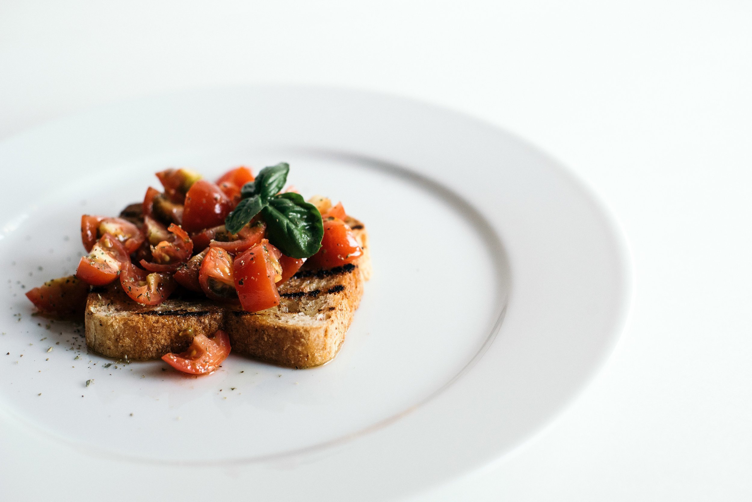 A plate with toast and tomatoes, a delicious and healthy breakfast option.jpg