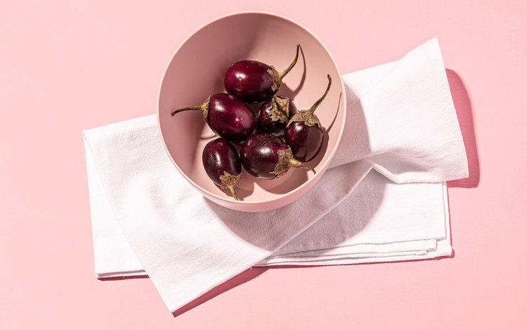 A bowl of cherries on a pink tablecloth, adds a touch of vibrant color to the scene.jpg
