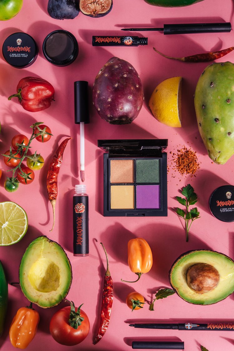 To capture cosmetics products various fruits and vegetables are beautifully arranged on a pink surface.jpg