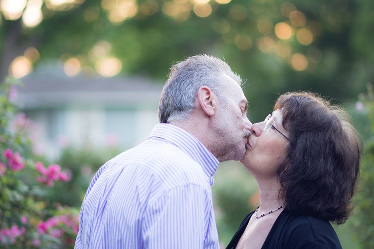 A couple in a garden, expressing their love through a passionate kiss. A captivating moment captured by a couple love photographer.jpg