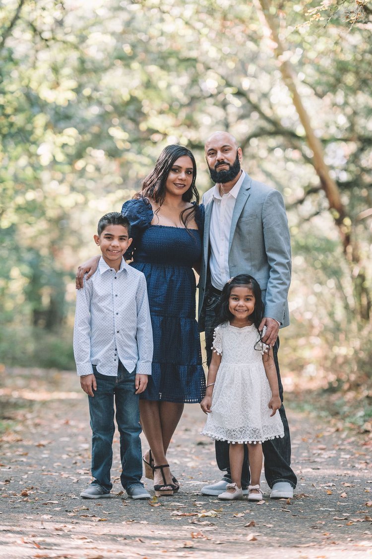A serene family portrait captured by the best family photographer amidst the enchanting woods.jpg