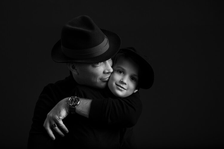 An image of a man hugging portrays a heartwarming moment between a father and son.jpg