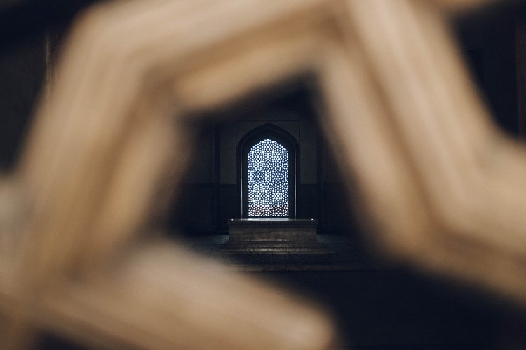 A photo of a historical architectural monument window framed by wood, taken by a travel photographer in the Sub-continent..jpg