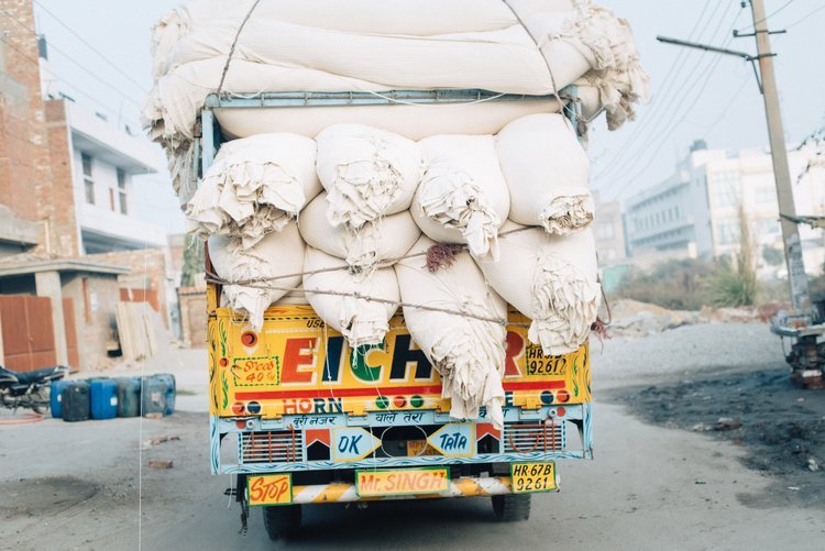 A truck in the Sub-continent carrying bags of sand on its back, captured by a travel photographer in Portland.jpg