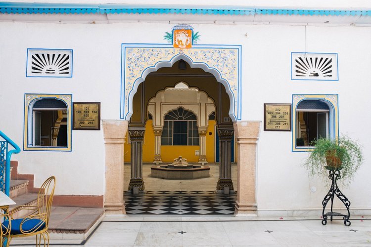 The entrance to a white building is adorned with blue and yellow decorations. Captured by a travel photographer in Portland.jpg
