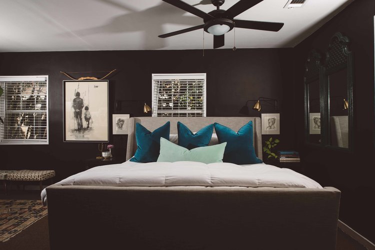 A beautifully designed bedroom featuring black walls and a ceiling fan, photographed by the best home interior photographer.jpg