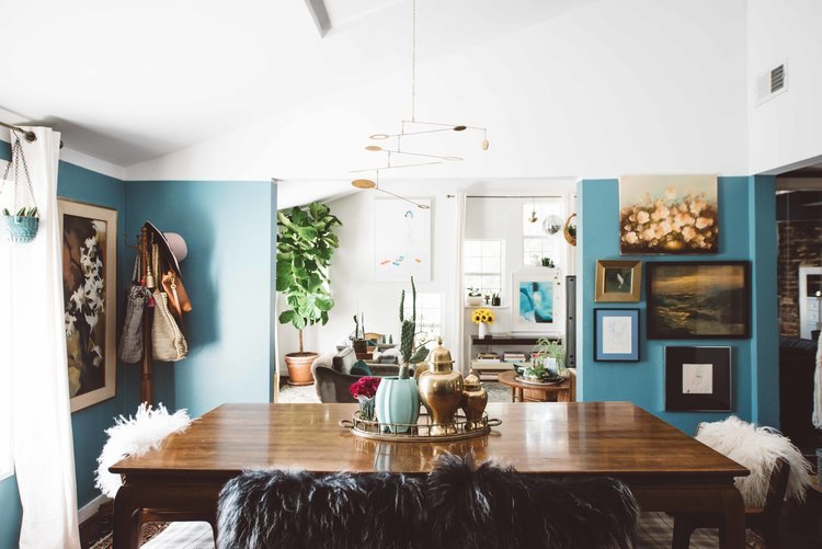 A dining room with blue walls and a wooden table, captured by the best home interior photographer in Portland, Oregon.jpg