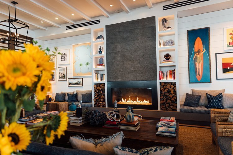 An amiable living room decorated with sunflowers and a fireplace, captured in an architectural and interior design photograph.jpg