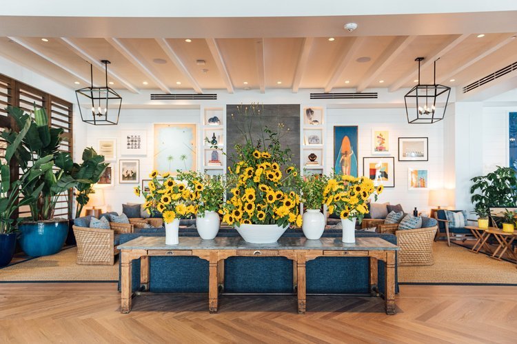 The hotel lobby showcases vibrant sunflowers and lush plants, creating a welcoming and refreshing atmosphere.jpg