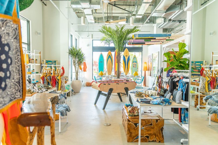 An architectural photograph of the interior of a surf store filled with surfboards and various items, perfect for surf enthusiasts.jpg