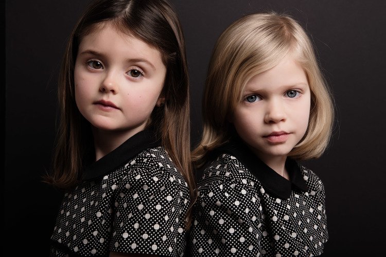 Two girls, with joyful expressions, pose for a fine art children&#39;s photography portrait.jpg