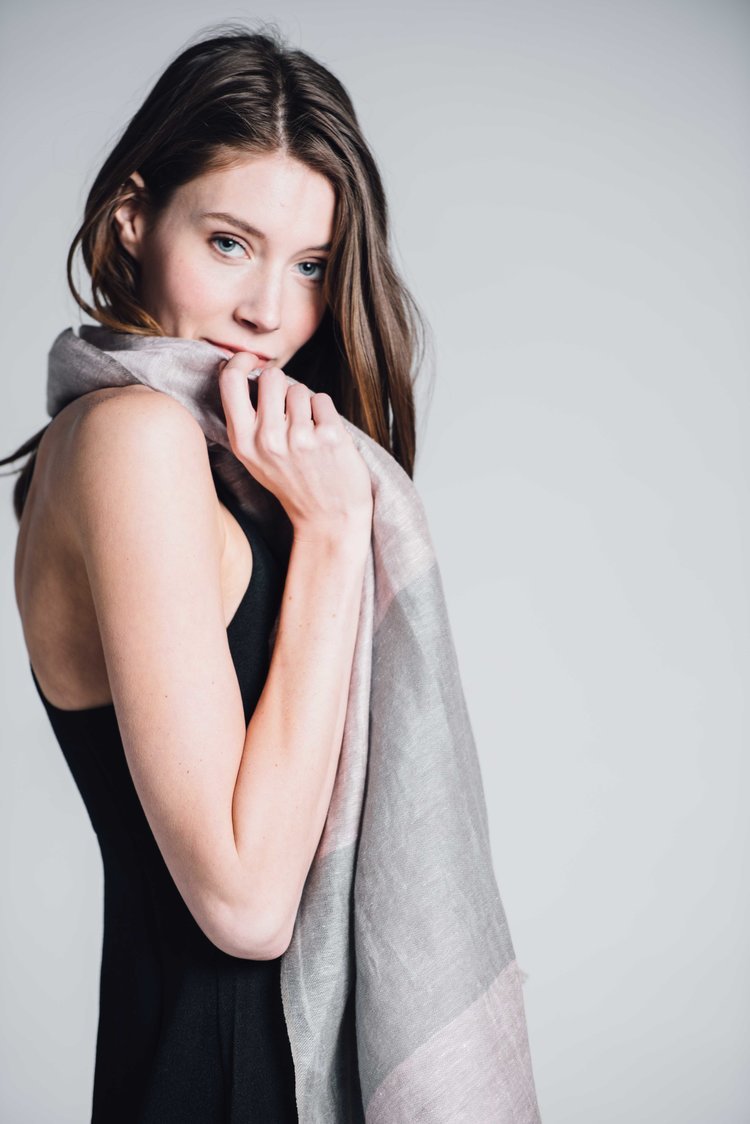 An image of a woman, styled by a studio lifestyle photographer, showcasing her grace with a gray scarf.jpg