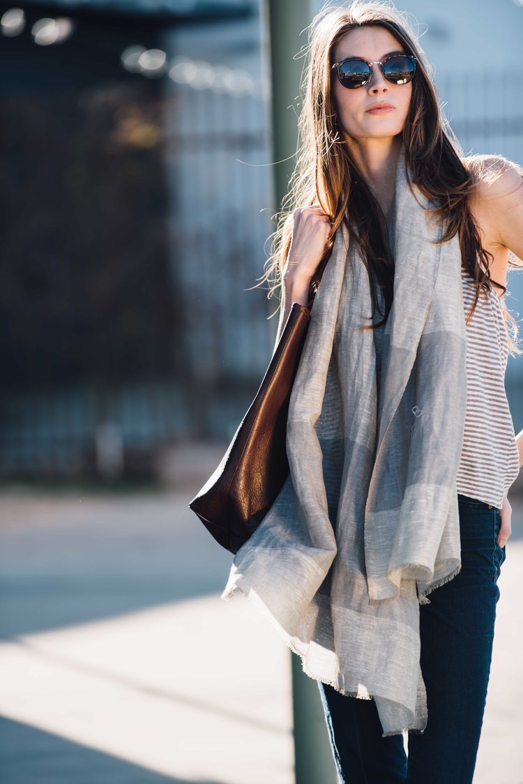A stylish woman wearing a scarf and sunglasses.jpg