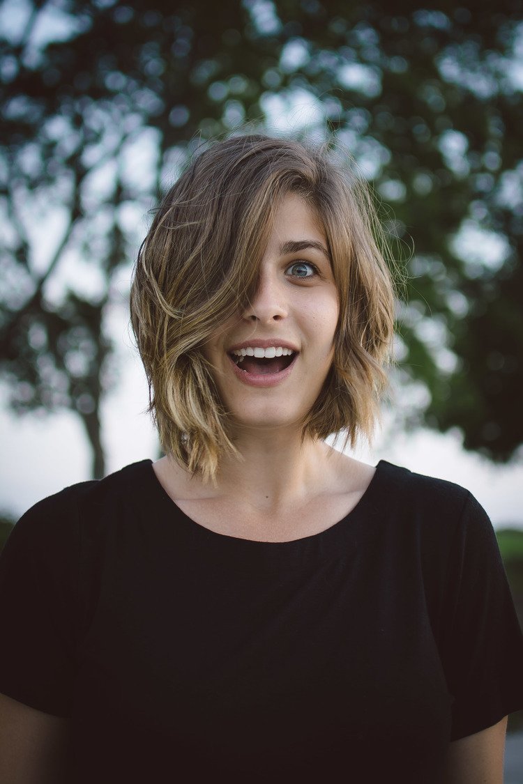 A stylish woman with short hair wearing a black top, captured in a lifestyle photography shot.jpg