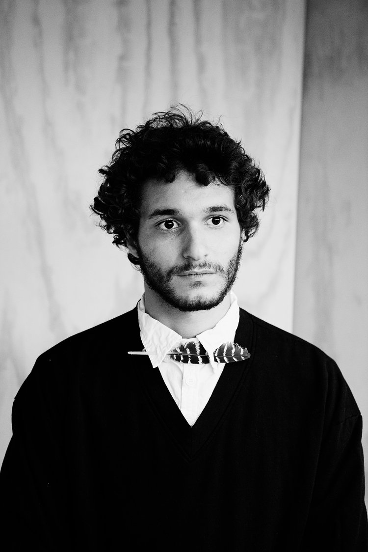 a black and white editorial photo of a man with curly hair.jpg
