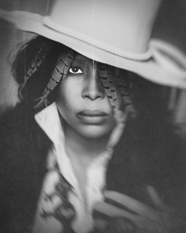a black and white photo of a woman wearing a hat posing for a photographer in Oregon.jpg
