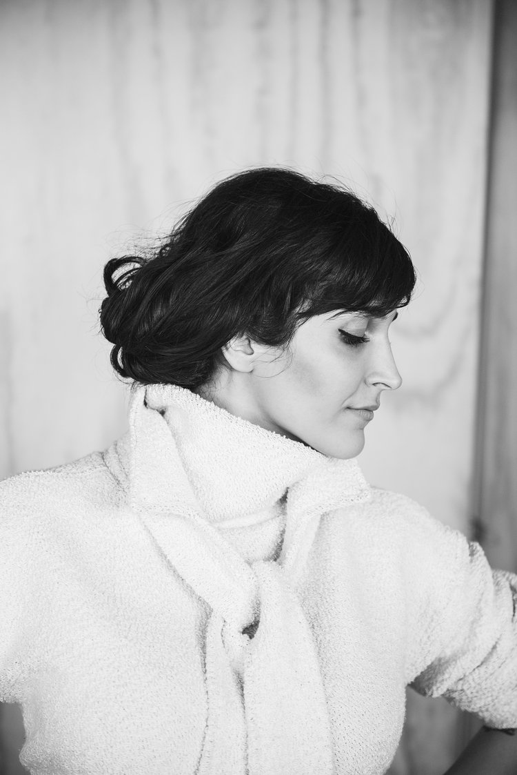 A private editorial featuring a woman in a white coat and a white scarf..jpg