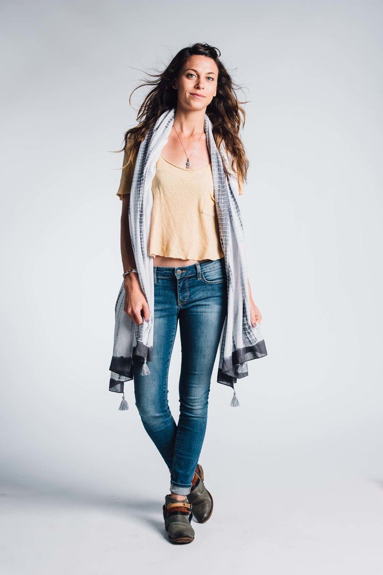 a woman in jeans and a scarf posing for a commercial editorial photo.jpg