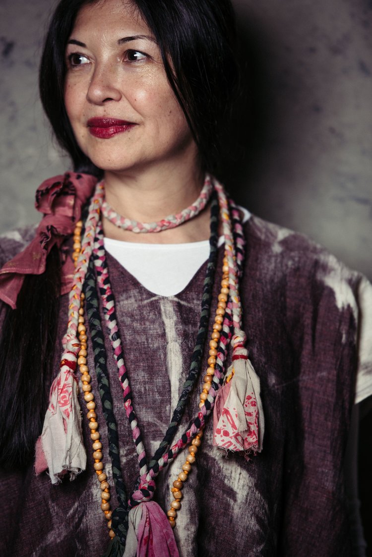 a woman wearing a necklace and earrings posed for the best editorial photographer in Portland..jpg