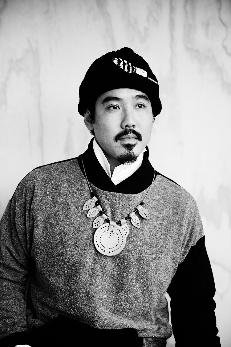 An editorial photographer from Portland captures a black and white photo of a asian man wearing a traditional neklace..jpg