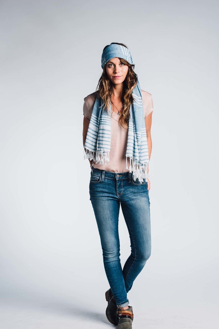 an indoor editorial portrait of a woman in jeans and a scarf.jpg
