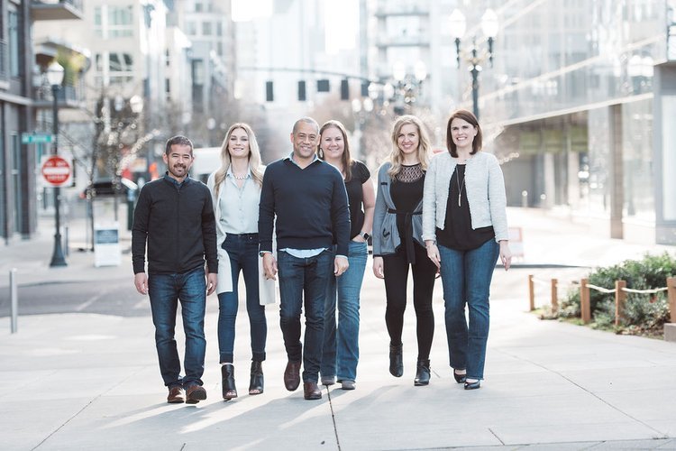 a group of company colleagues standing for headshots on a city sidewalk, Portland.jpeg