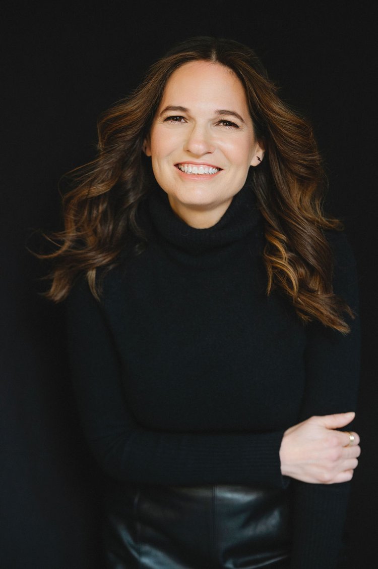 A model in a black turtleneck and leather pants posing for headshots.jpg