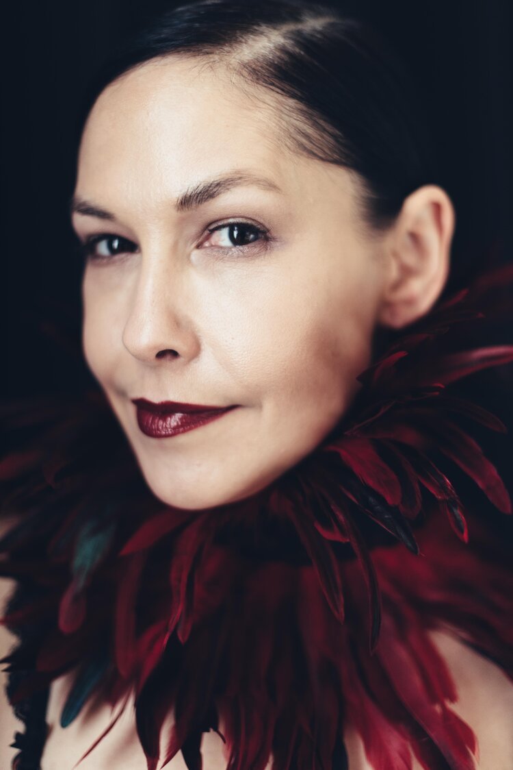 A Portland headshot photographer photographed a woman wearing a red feathered choker.jpg