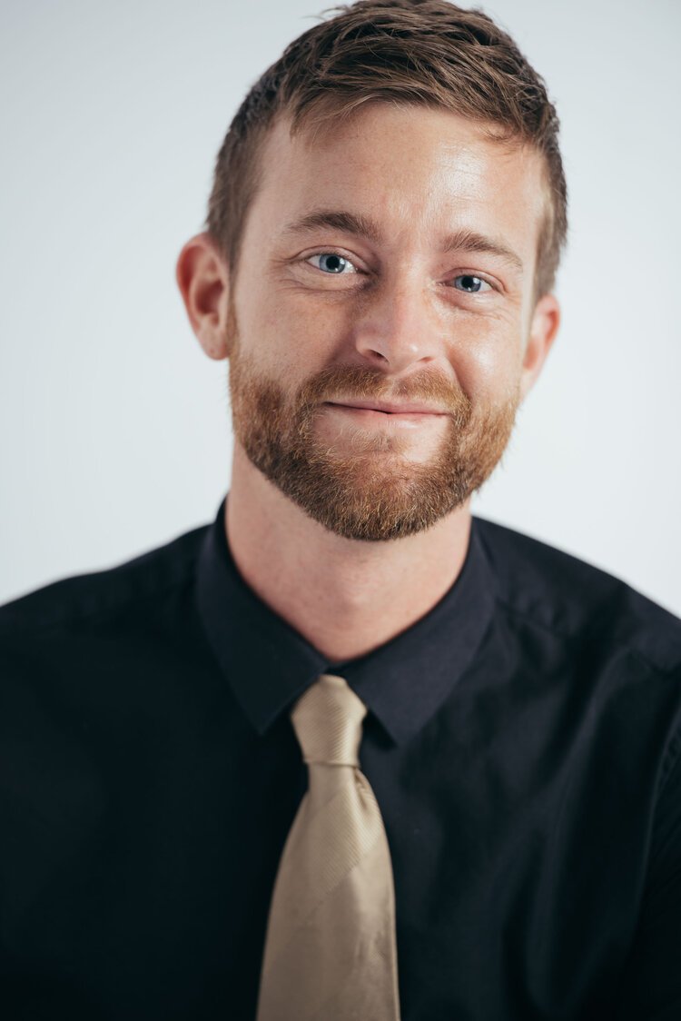 a professional man wearing a black shirt and tie for Linked In profile headshots.jpg