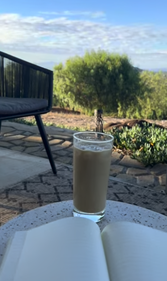 journal with an iced latte and valley views