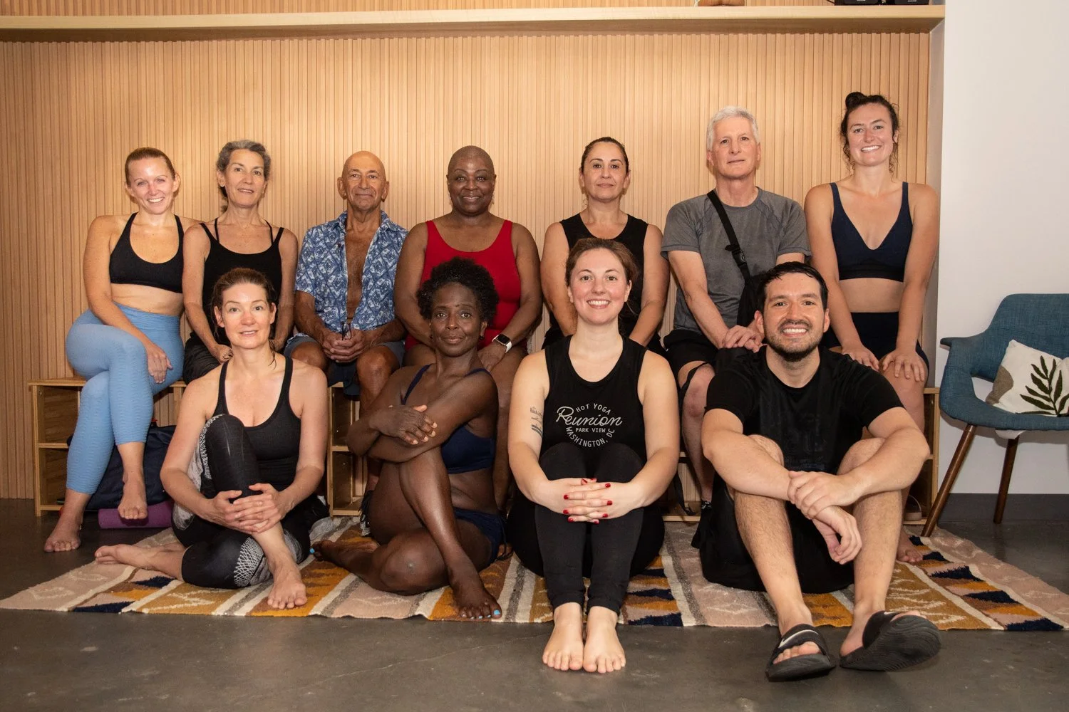 Yoga students smiling in the Reunion Hot Yoga lobby