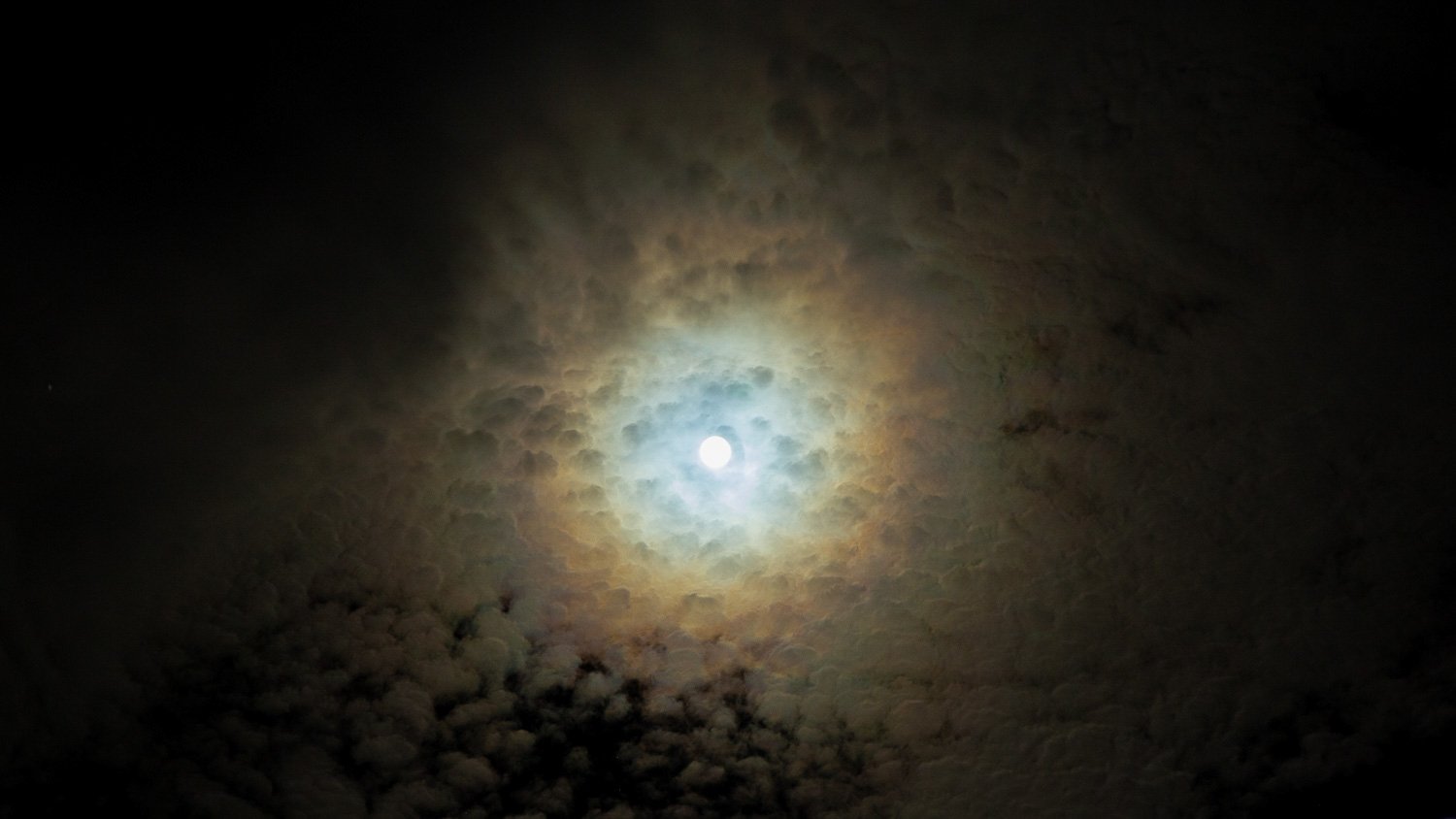 Curly Clouds in a Halo Rainbow at Night