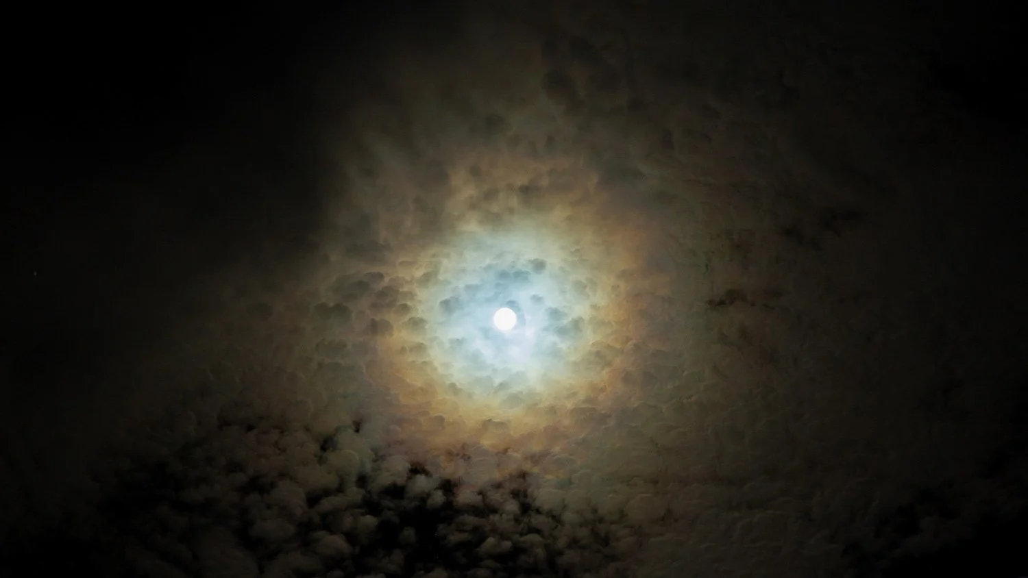 Curly Clouds in a Halo Rainbow at Night photographed by Tyrone Z. McCants