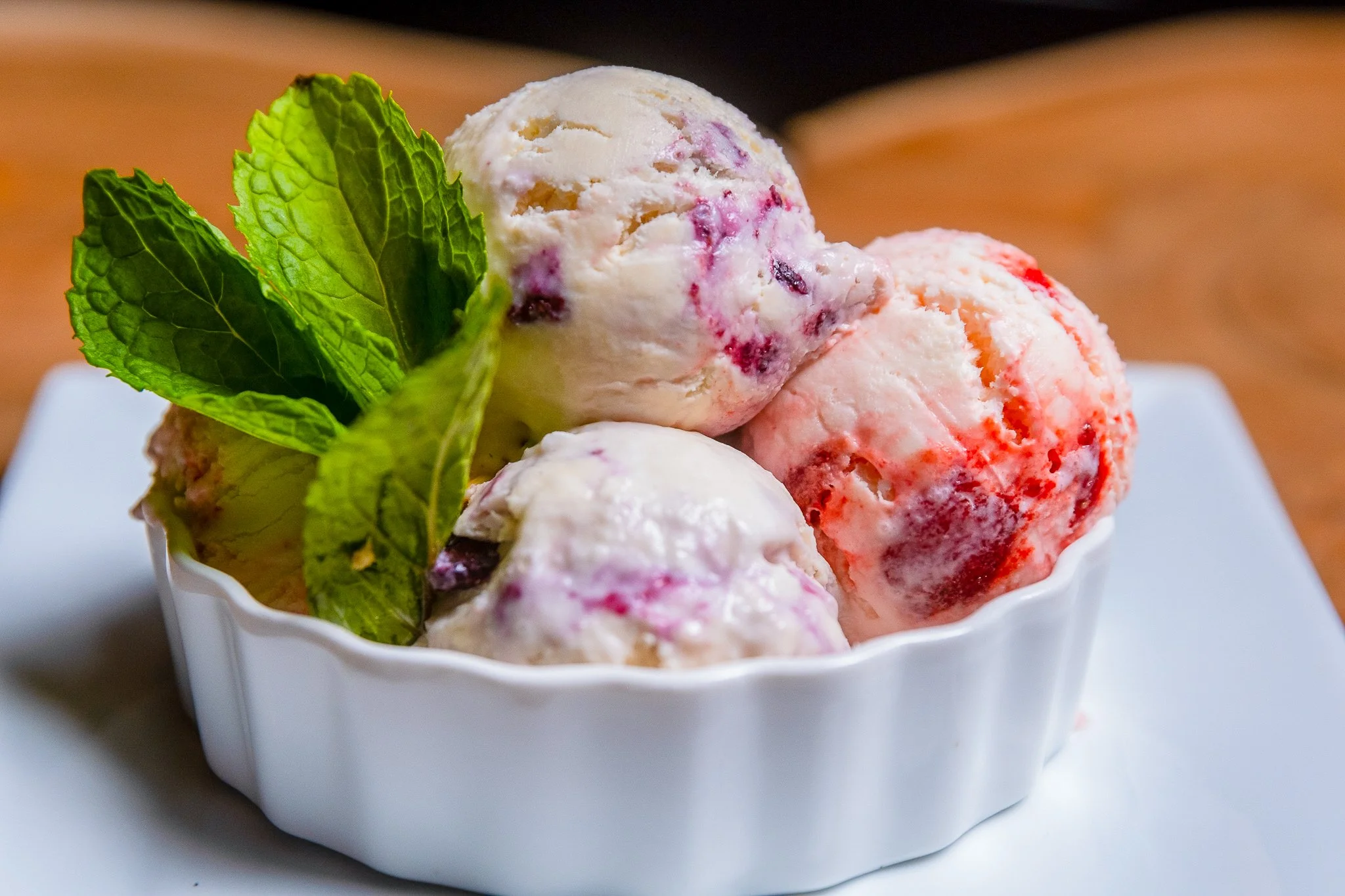 Best dessert photography cheesecake ice cream three scoops in bowl with fresh mint leaves in New York City and shot by Lumumba David from David Media Group