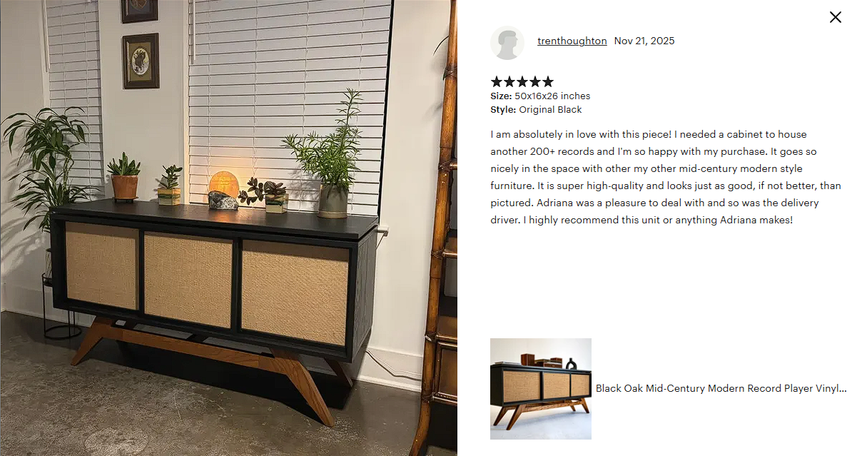 A black mid-century modern cabinet with three woven rattan sliding doors, wooden angled legs, and a black top, decorated with potted plants and a Himalayan salt lamp, against a white wall with window blinds.