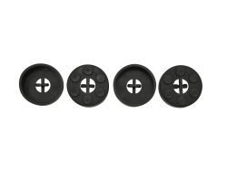 Four black, round objects with cross-shaped cutouts in the center, aligned in a row.