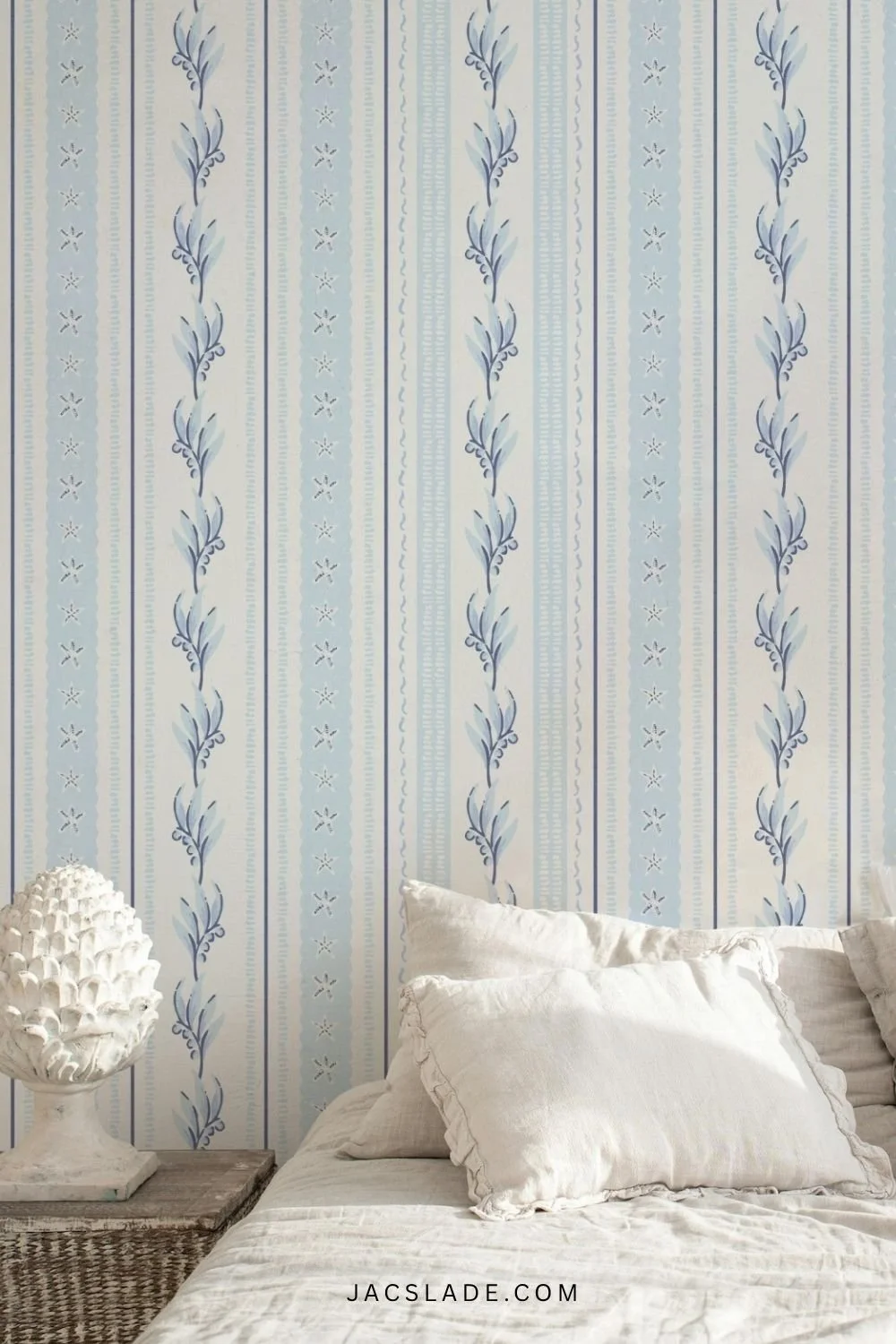 Blue and white coastal striped wallpaper in boho white bedroom