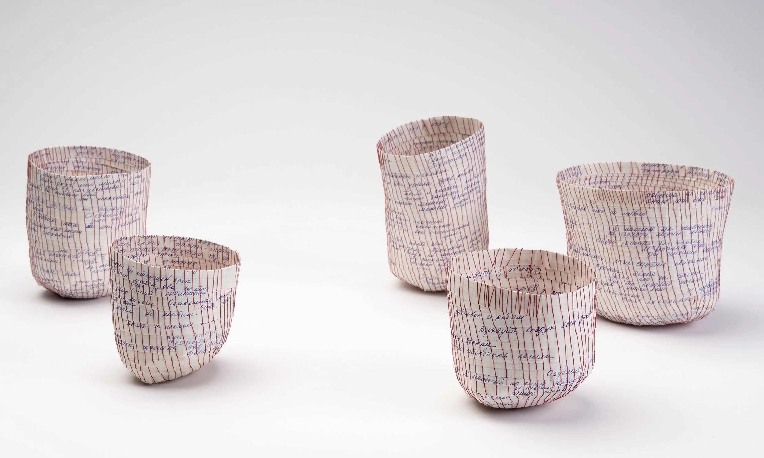 Unveiled Enigma collection, 2026
hand-stitched poetry on graph paper, silk thread
five vessels, dimensions variable