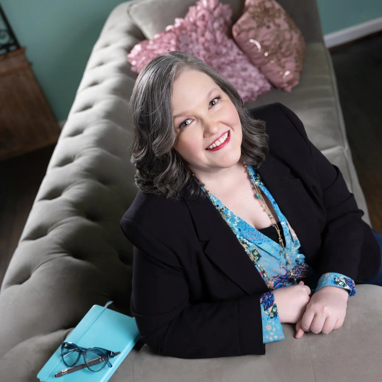 woman sitting on a sofa looking up at camera